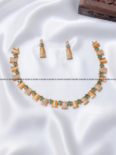 Emerald green leaf motif AD stone necklace set with gold leaf panels and matching earrings, RARUS Jewels