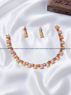 Ruby red leaf motif AD stone necklace set with gold leaf panels and matching earrings, RARUS Jewels